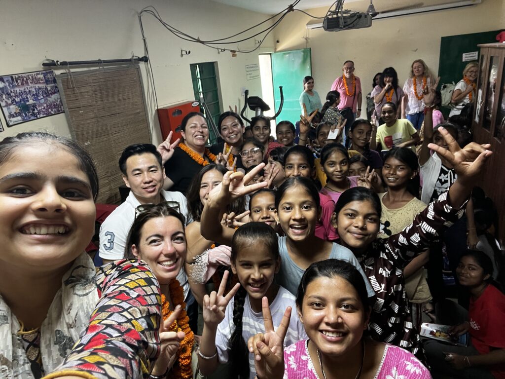 A group of women and girls smiling