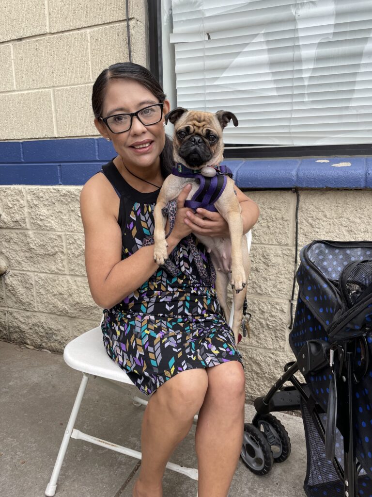 Woman on chair holding dog