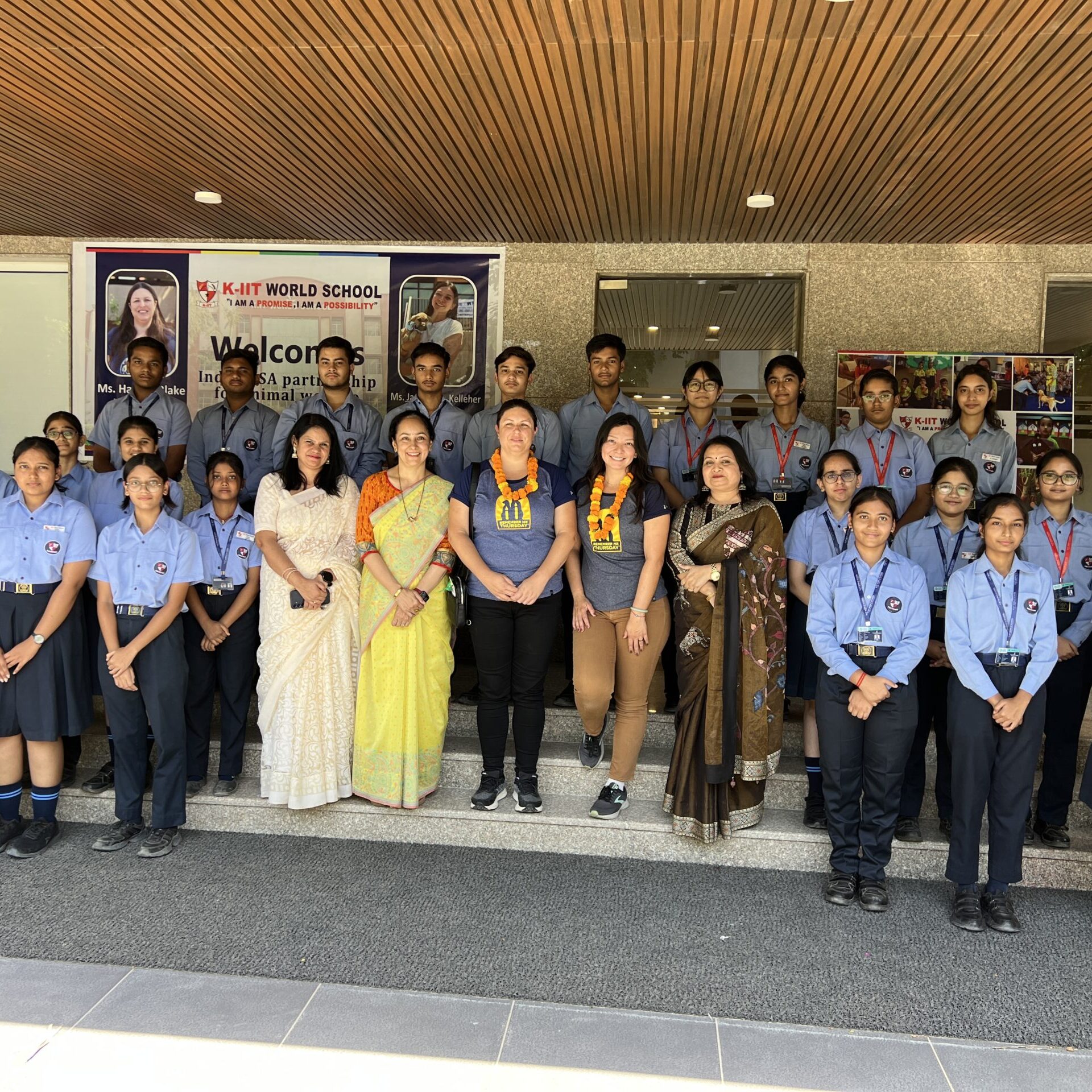 A group of educators and students in India posing for a photo
