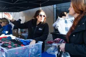 Kristine handing out clothing