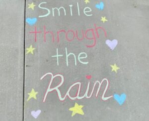 Smile Through The Rain written in chalk