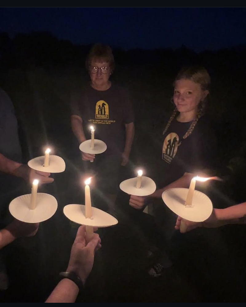 people in remember me Thursday t shirt holding candles
